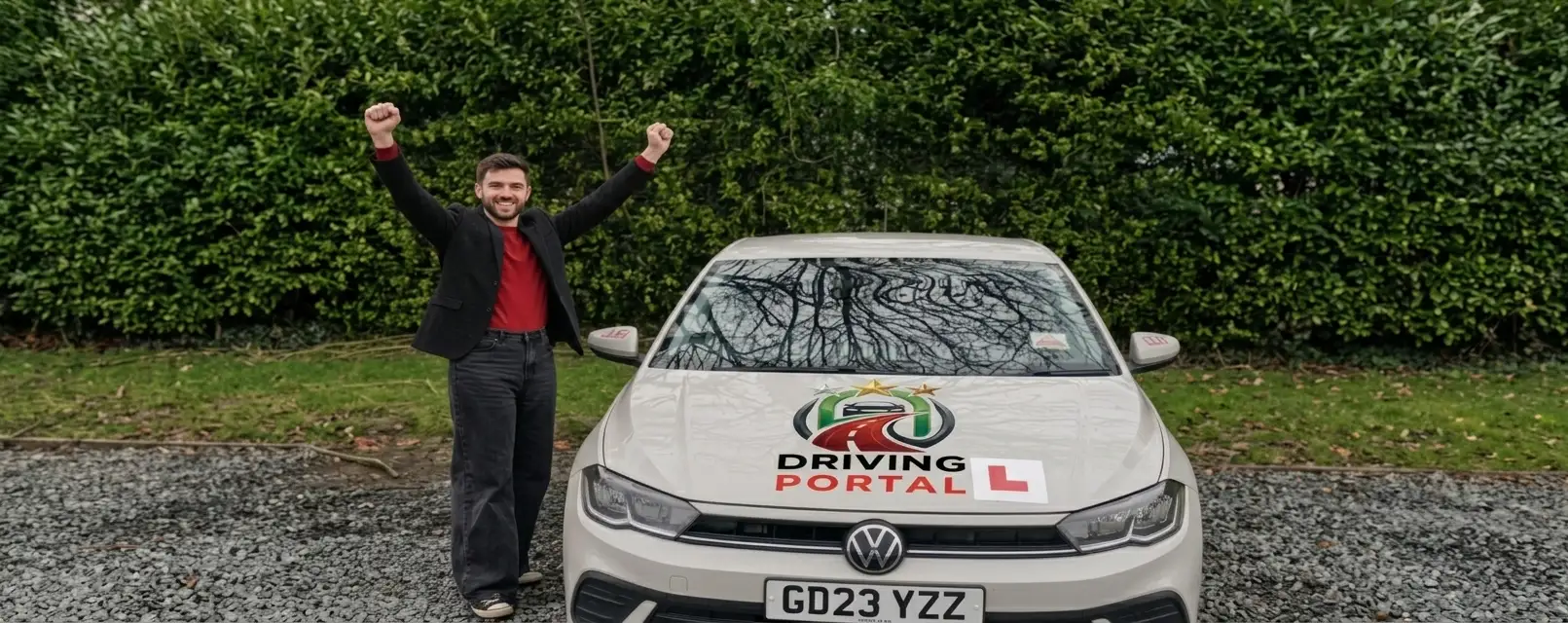 Learner celebrating beside a Driving Portal branded learner car