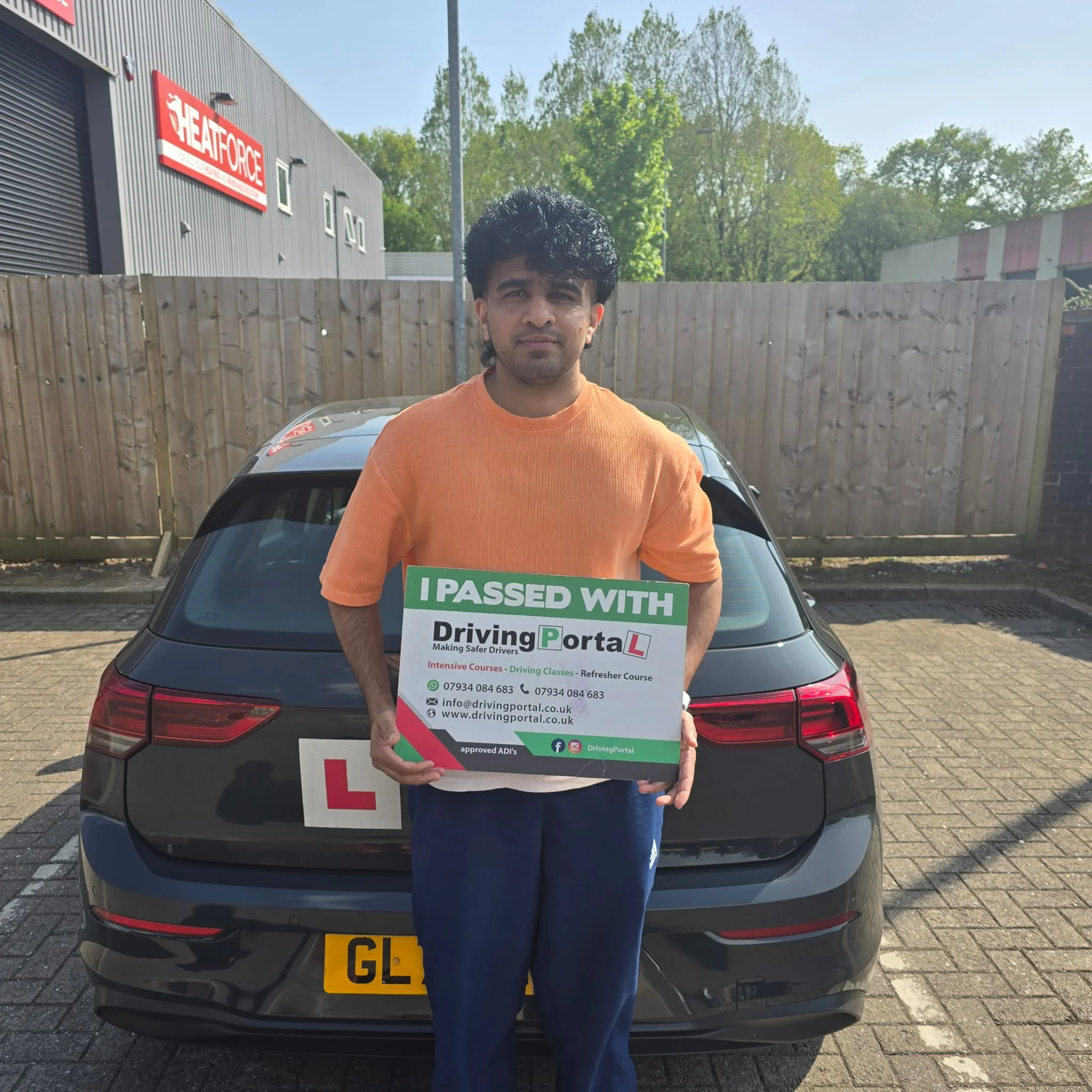 Driving Portal learner beside a tuition car